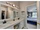 Beautiful primary bath with double sinks, vanity area, and doorway leading to the spacious bedroom at 3668 Burel Mill Dr, Buford, GA 30519