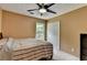 Cozy bedroom featuring a ceiling fan, window overlooking the yard, and a built-in closet at 3668 Burel Mill Dr, Buford, GA 30519