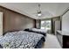 Bedroom with two beds, ceiling fan, and windows offering natural light and neighborhood views at 3668 Burel Mill Dr, Buford, GA 30519