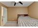 Bedroom featuring a ceiling fan, window overlooking the yard, and an open doorway at 3668 Burel Mill Dr, Buford, GA 30519