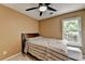 Bedroom with a ceiling fan, window overlooking the greenery, and baseboard electrical outlet at 3668 Burel Mill Dr, Buford, GA 30519