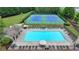 Community pool and tennis courts with ample lounge chairs and well-maintained landscaping at 3668 Burel Mill Dr, Buford, GA 30519