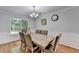 Cozy dining room showcasing a chandelier, table set, and neutral wall paint at 3668 Burel Mill Dr, Buford, GA 30519