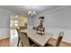 Dining room features an archway and hardwood floors with a view of the front yard at 3668 Burel Mill Dr, Buford, GA 30519