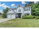 Charming two-story home with a well-manicured lawn, two-car garage, and inviting entrance at 3668 Burel Mill Dr, Buford, GA 30519
