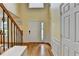 Warm and inviting foyer with hardwood floors, a staircase featuring iron spindles, and paneled wall accents at 3668 Burel Mill Dr, Buford, GA 30519