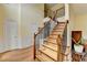 Welcoming foyer featuring hardwood floors, a staircase with iron spindles, and paneled wall accents at 3668 Burel Mill Dr, Buford, GA 30519