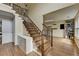 Inviting foyer featuring beautiful hardwood floors, a staircase with iron spindles, and a storage console at 3668 Burel Mill Dr, Buford, GA 30519