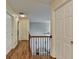 Well-lit hallway featuring hardwood floors and access to several rooms with white doors at 3668 Burel Mill Dr, Buford, GA 30519