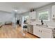 Open kitchen with hardwood floors, stainless steel appliances, and a fireplace at 3668 Burel Mill Dr, Buford, GA 30519
