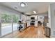 Bright kitchen features white cabinetry, stainless steel appliances, and hardwood floors with a view to the backyard at 3668 Burel Mill Dr, Buford, GA 30519