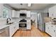 Spacious kitchen featuring modern appliances, white cabinets, and a view to the dining room at 3668 Burel Mill Dr, Buford, GA 30519