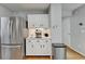 Kitchen area with stainless steel refrigerator and white cabinets at 3668 Burel Mill Dr, Buford, GA 30519
