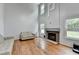Living room featuring high ceilings, tall windows, a fireplace and hardwood floors at 3668 Burel Mill Dr, Buford, GA 30519