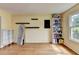 Bright living room with hardwood floors, a large window, and modern shelving displays at 3668 Burel Mill Dr, Buford, GA 30519