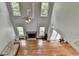 Bright living room with hardwood floors, fireplace, ceiling fan, and lots of natural light from multiple windows at 3668 Burel Mill Dr, Buford, GA 30519