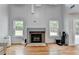 Bright living room featuring a fireplace, hardwood floors, and lots of natural light at 3668 Burel Mill Dr, Buford, GA 30519