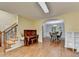 Bright living room with hardwood floors leads to the dining room with wainscotting, archway, and elegant table set at 3668 Burel Mill Dr, Buford, GA 30519