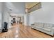 Open-concept living room with hardwood floors and a view of the second-story balcony at 3668 Burel Mill Dr, Buford, GA 30519