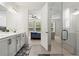 Modern bathroom featuring double vanity, large mirror, access to a walk-in shower and a bedroom, and neutral tiling at 5121 Aster Bnd, Canton, GA 30114