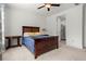 Comfortable bedroom with a wooden bed frame, plush bedding, side tables, and ample natural light at 5121 Aster Bnd, Canton, GA 30114
