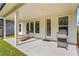 Inviting covered patio with a lounger, grill, and seamless access to the backyard at 5121 Aster Bnd, Canton, GA 30114