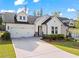 Beautifully landscaped front yard and a two-car garage at 5121 Aster Bnd, Canton, GA 30114