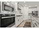 Modern kitchen features stainless steel appliances, granite countertops, and a center island at 5121 Aster Bnd, Canton, GA 30114
