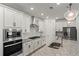 Modern kitchen with stainless steel appliances, granite countertops, and white cabinets at 5121 Aster Bnd, Canton, GA 30114