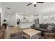 Open-concept kitchen and living area with hardwood floors and lots of natural light at 5121 Aster Bnd, Canton, GA 30114