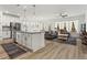 Open-concept kitchen and living area with hardwood floors and lots of natural light at 5121 Aster Bnd, Canton, GA 30114