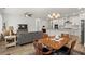 Spacious living and dining area featuring an open floor plan with white walls, wood flooring, and modern lighting at 5121 Aster Bnd, Canton, GA 30114