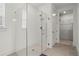 Sleek, walk-in shower with glass enclosure, tiled walls, modern fixtures, and access to a walk-in closet at 5121 Aster Bnd, Canton, GA 30114