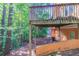 View of the wooden deck with natural wooded backyard at 7074 Springgrove Ct, Austell, GA 30168
