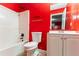 Bright bathroom with white cabinets, white bath tub, and red walls at 7074 Springgrove Ct, Austell, GA 30168