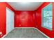 Red bedroom featuring carpet and a closet at 7074 Springgrove Ct, Austell, GA 30168