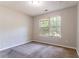 Neutral bedroom with large window providing natural light at 7074 Springgrove Ct, Austell, GA 30168
