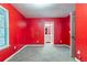 Cozy bedroom with gray carpet, bright red walls, and a doorway to the ensuite bathroom at 7074 Springgrove Ct, Austell, GA 30168
