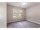 Neutral bedroom with large window providing natural light at 7074 Springgrove Ct, Austell, GA 30168