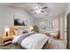 Staged bedroom with ceiling fan and large window with natural light at 7074 Springgrove Ct, Austell, GA 30168