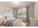 Bright, virtually staged bedroom with a full bed and natural light at 7074 Springgrove Ct, Austell, GA 30168