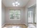 Bright dining area with large window and chandelier lighting at 7074 Springgrove Ct, Austell, GA 30168