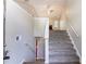 Inviting entryway with staircase and view of the living room fireplace at 7074 Springgrove Ct, Austell, GA 30168