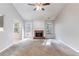 Spacious living room with a cozy brick fireplace and large windows at 7074 Springgrove Ct, Austell, GA 30168