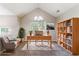 Office area with large window, built-in shelving, and vaulted ceiling at 7074 Springgrove Ct, Austell, GA 30168