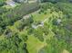 Wide aerial view of property showing large lawn, trees, and houses at 105 Tranquility Dr, Villa Rica, GA 30180