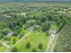 Expansive aerial view of a property with a house, large lawn, and surrounding dense woodland at 105 Tranquility Dr, Villa Rica, GA 30180