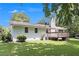 View of the rear of a white brick home with a wooden deck and a green lawn at 105 Tranquility Dr, Villa Rica, GA 30180