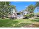 Backyard view of a white brick home with a deck and a chimney at 105 Tranquility Dr, Villa Rica, GA 30180