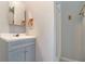 Bathroom with updated gray vanity, sink, framed mirror, and tile flooring at 105 Tranquility Dr, Villa Rica, GA 30180